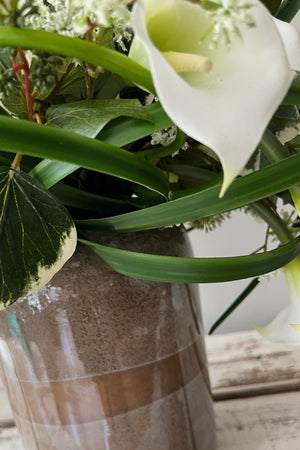 Calla Lilies with Japanese Knotweed and Ivy in a Gold/Taupe Glass Vase