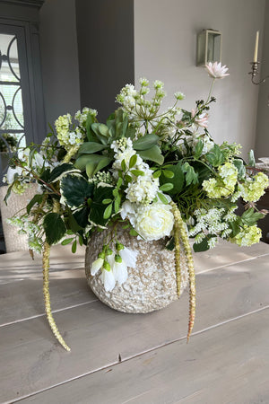 Ranunculus and Campanulas in a Textured Stone Vase