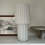 Textured vase on a shelf with a neutral background Rtfact