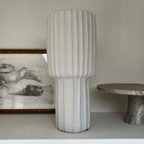 Textured vase on a shelf with a neutral background Rtfact