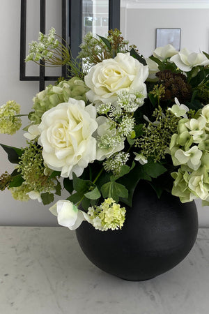 Hellebores, Roses and Snowball in a Black Metal Vase