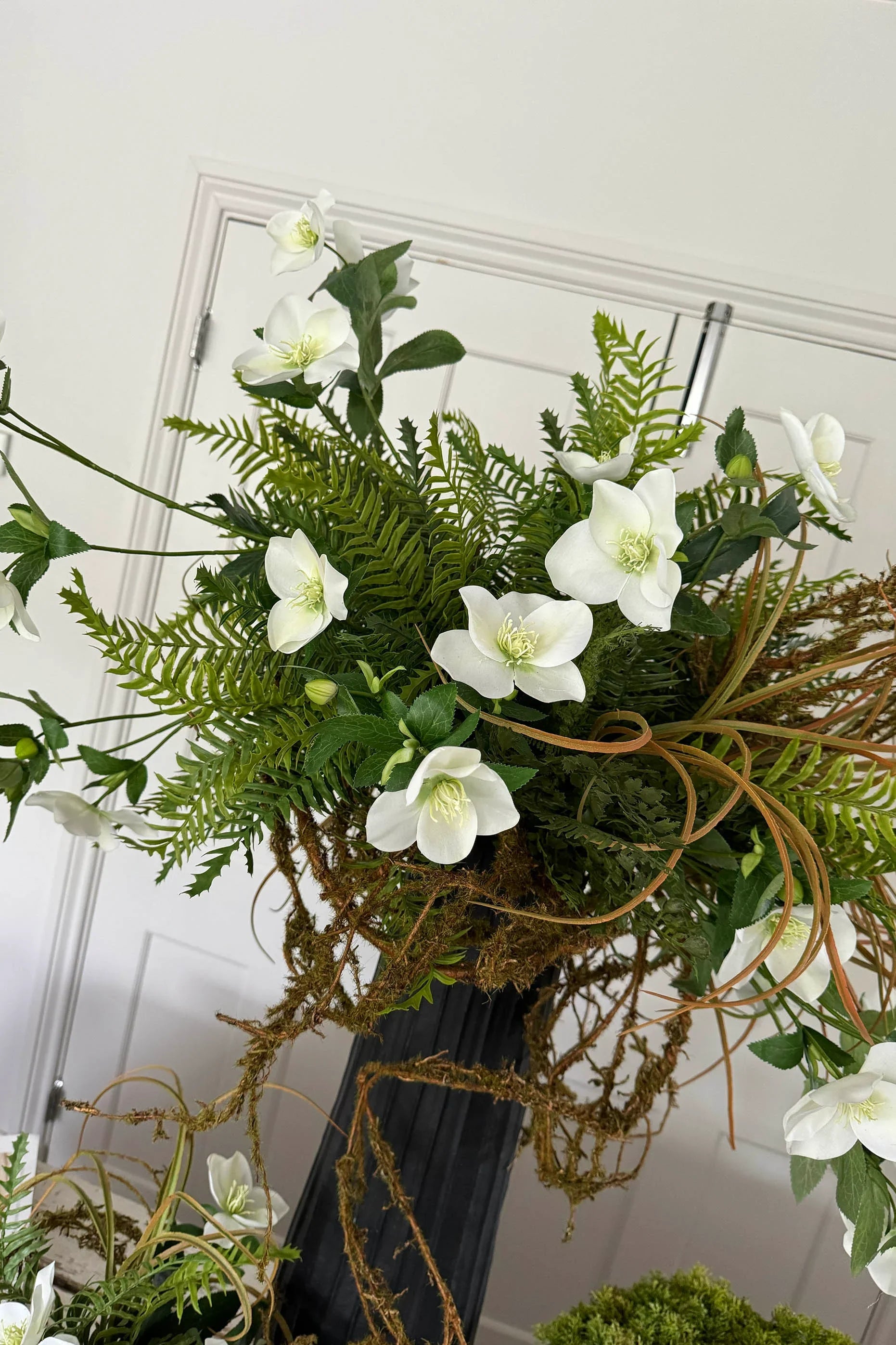 Hellebore, Ferns and Mossy Twig in a Black Ridged Vase RTfact Flowers 