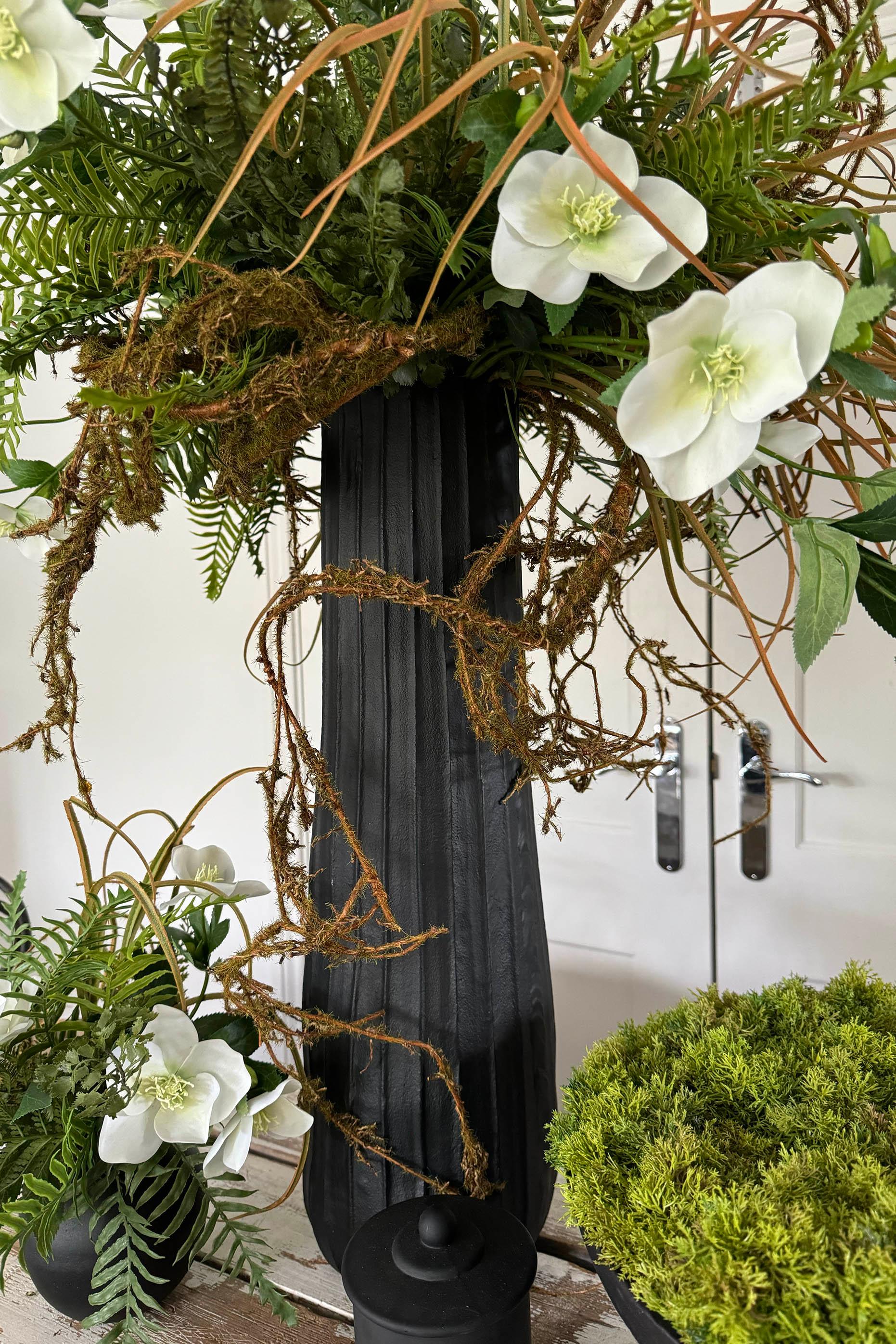 Hellebore, Ferns and Mossy Twig in a Black Ridged Vase RTfact Flowers 