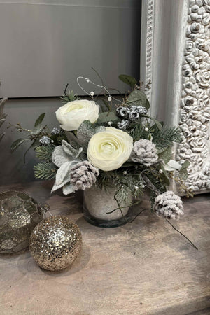 Ranunculus, Frosted Pine Cones and Berries in a Snow filled Glass Cylinder