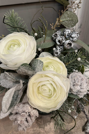 Ranunculus, Frosted Pine Cones and Berries in a Snow filled Glass Cylinder