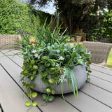 Faux Grasses, Greenery and Waxflower in a Ribbed Grey Bowl. UV resistant artificial greenery. Rtfact flowers