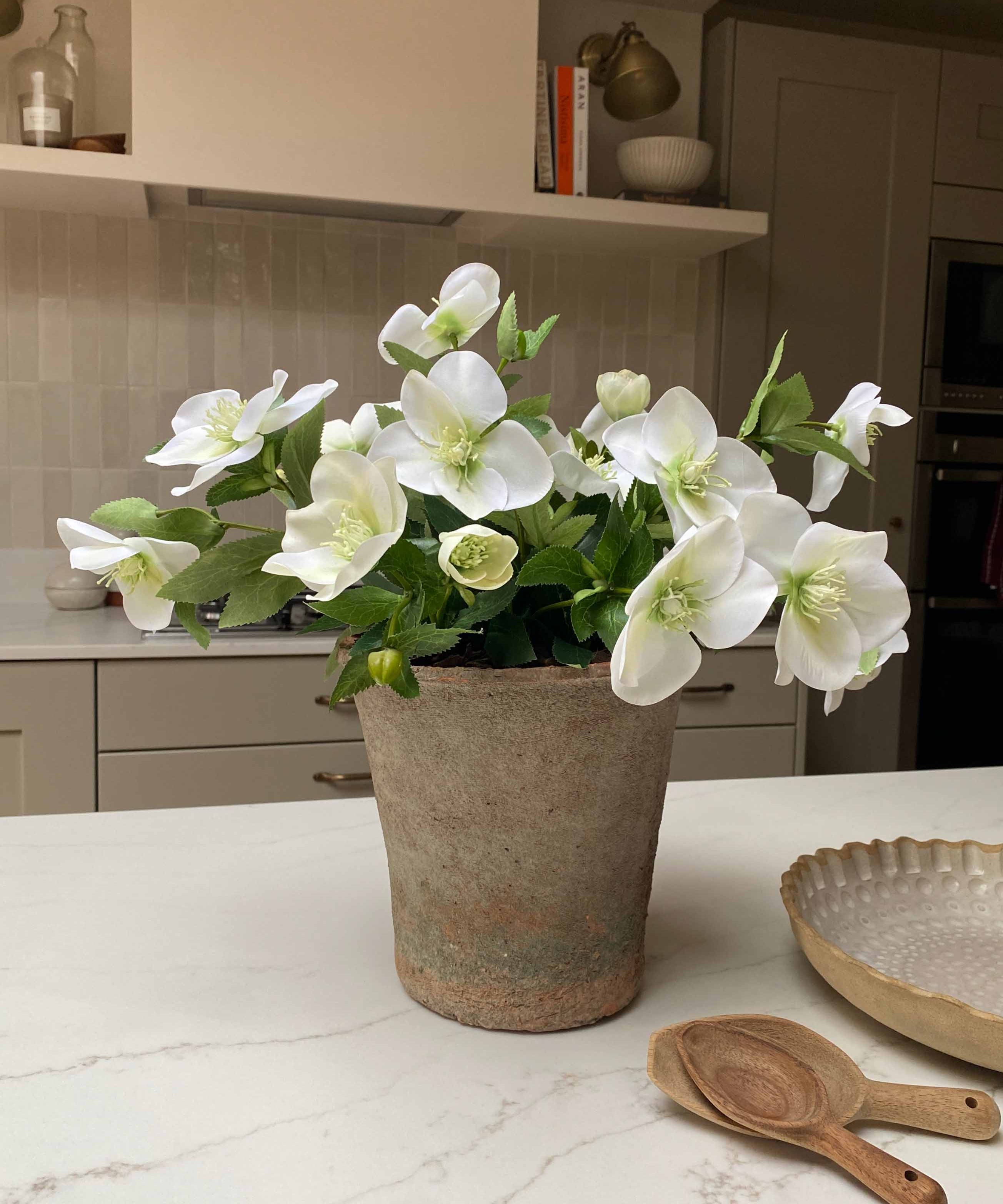Faux flower bouquet plant on a kitchen counter with a neutral color scheme