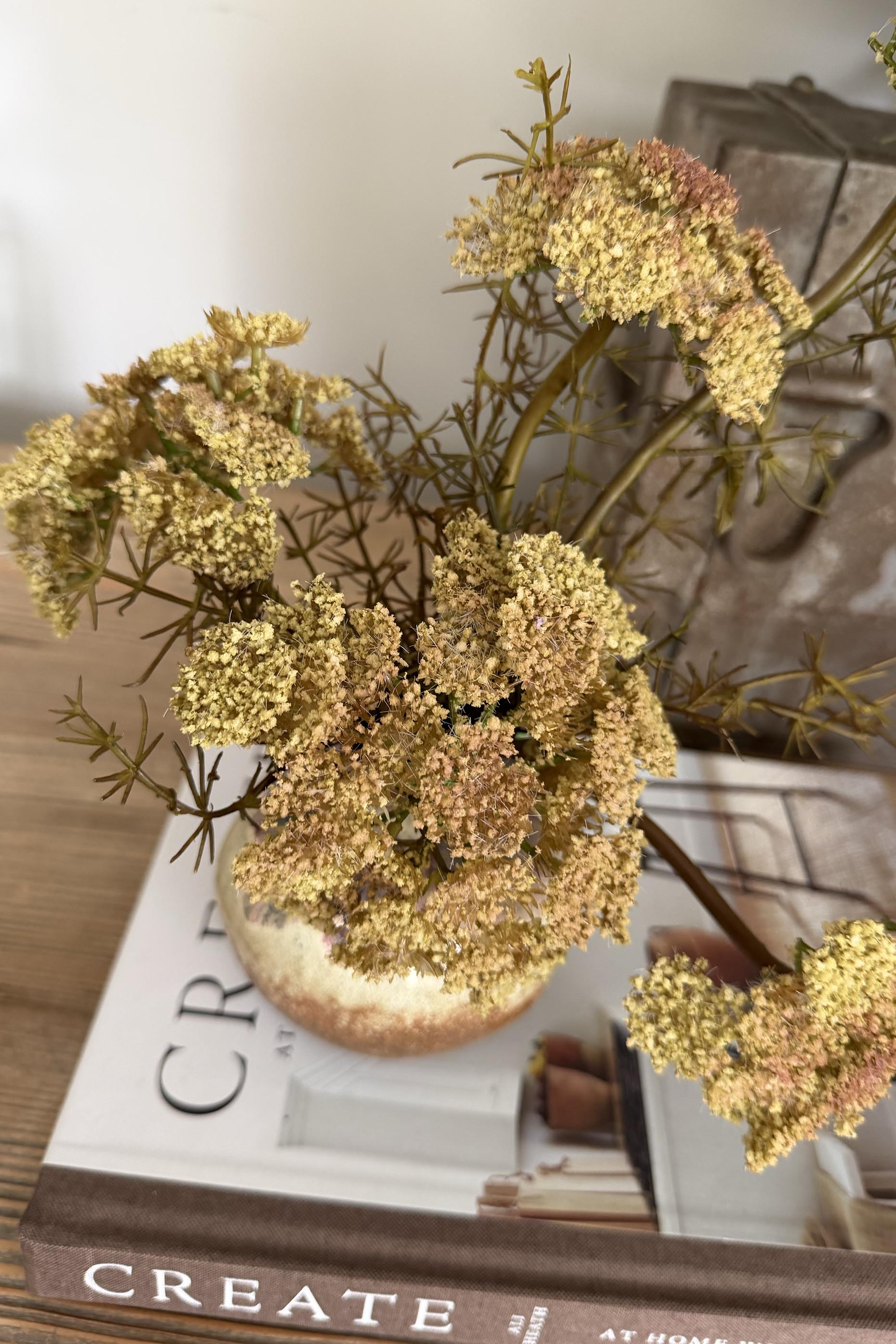 Decorative arrangement of flowers on a book with a blurred background