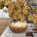 Decorative vase with flowers on a magazine titled 'Create'.