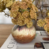 Decorative vase with flowers on a magazine titled 'Create'.
