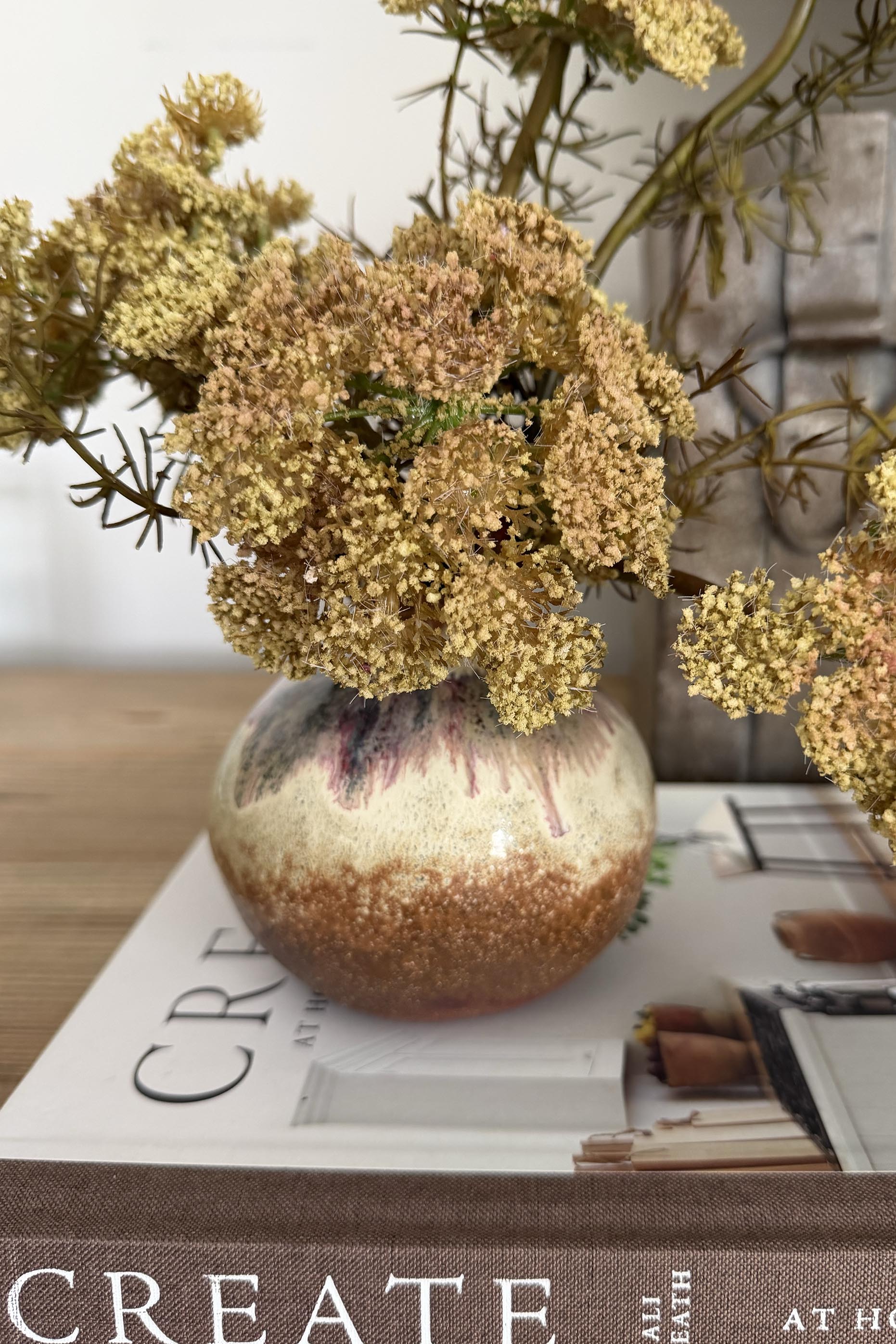 Decorative vase with flowers on a magazine titled 'Create'.