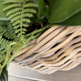 Dancing Orchids, Fern and Twigs in a Rattan Basket