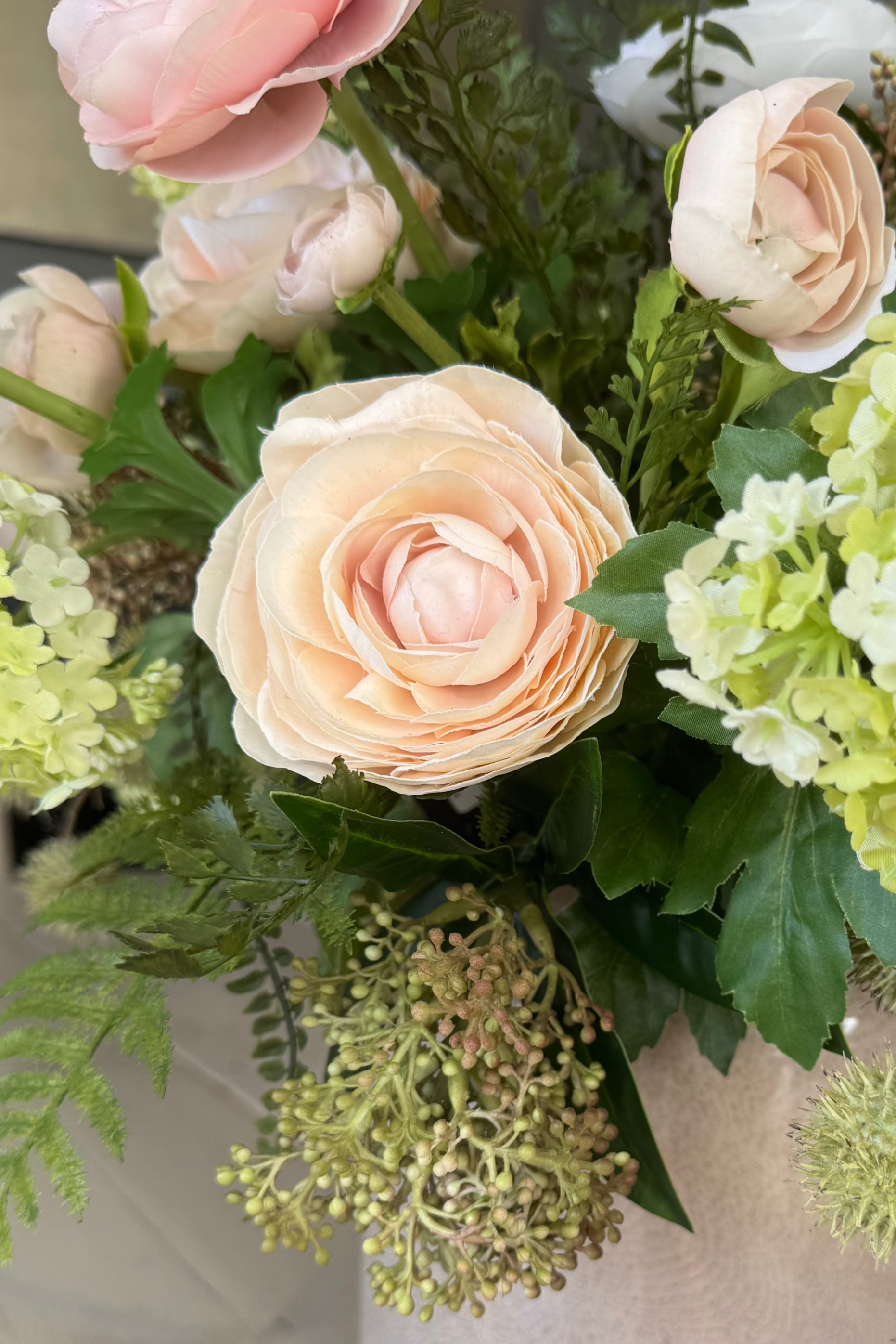 Ranunculus, Viburnum and Skimmia in a Taupe Glass Vase RTfact Flowers 
