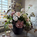 Eucalyptus, Roses, Hydrangeas and Ranunuculus in a Brown Stone Pot