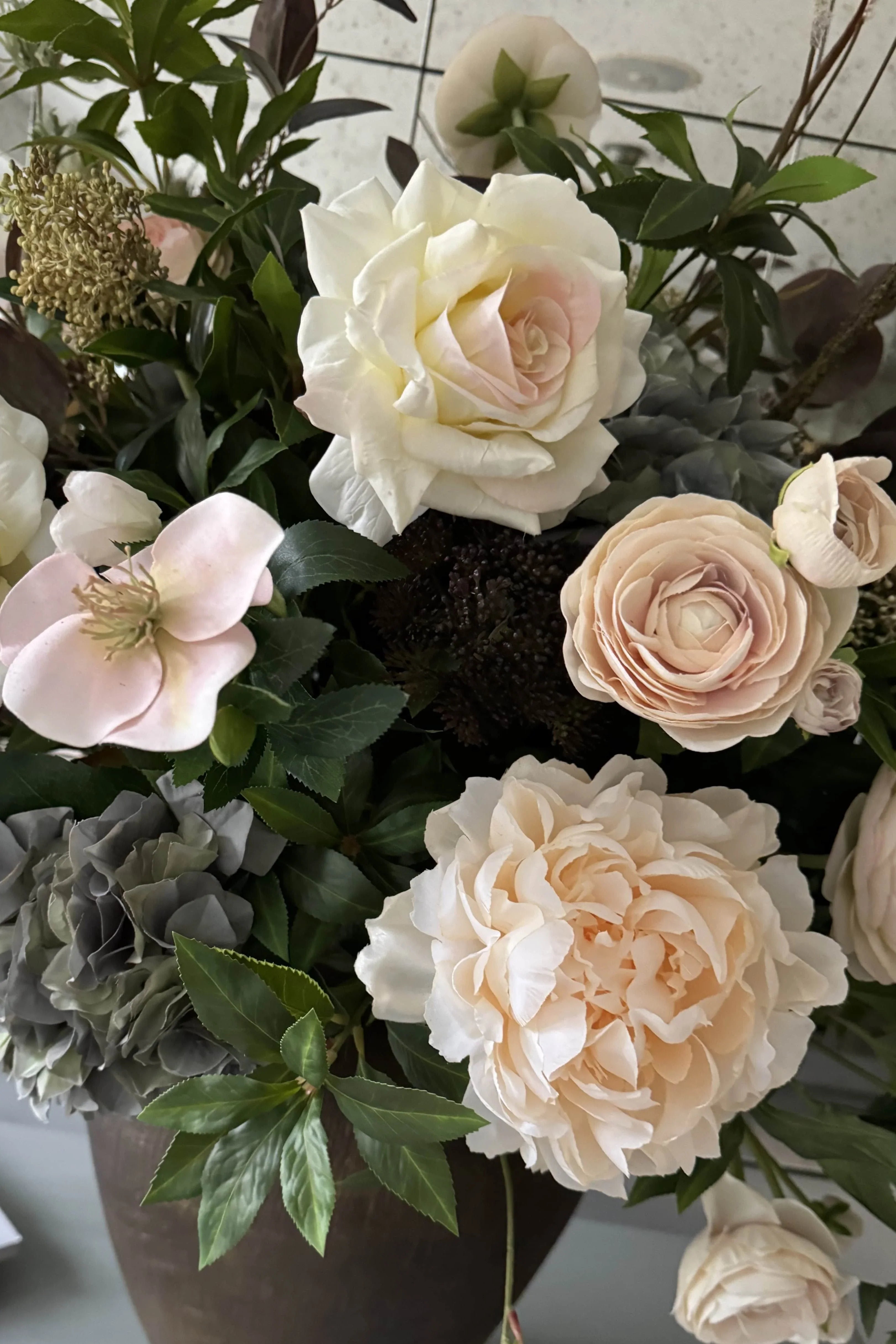 Ranunculus, Roses, Bucida and Eucalyptus in a Textured Bronze Vase RTfact Flowers 
