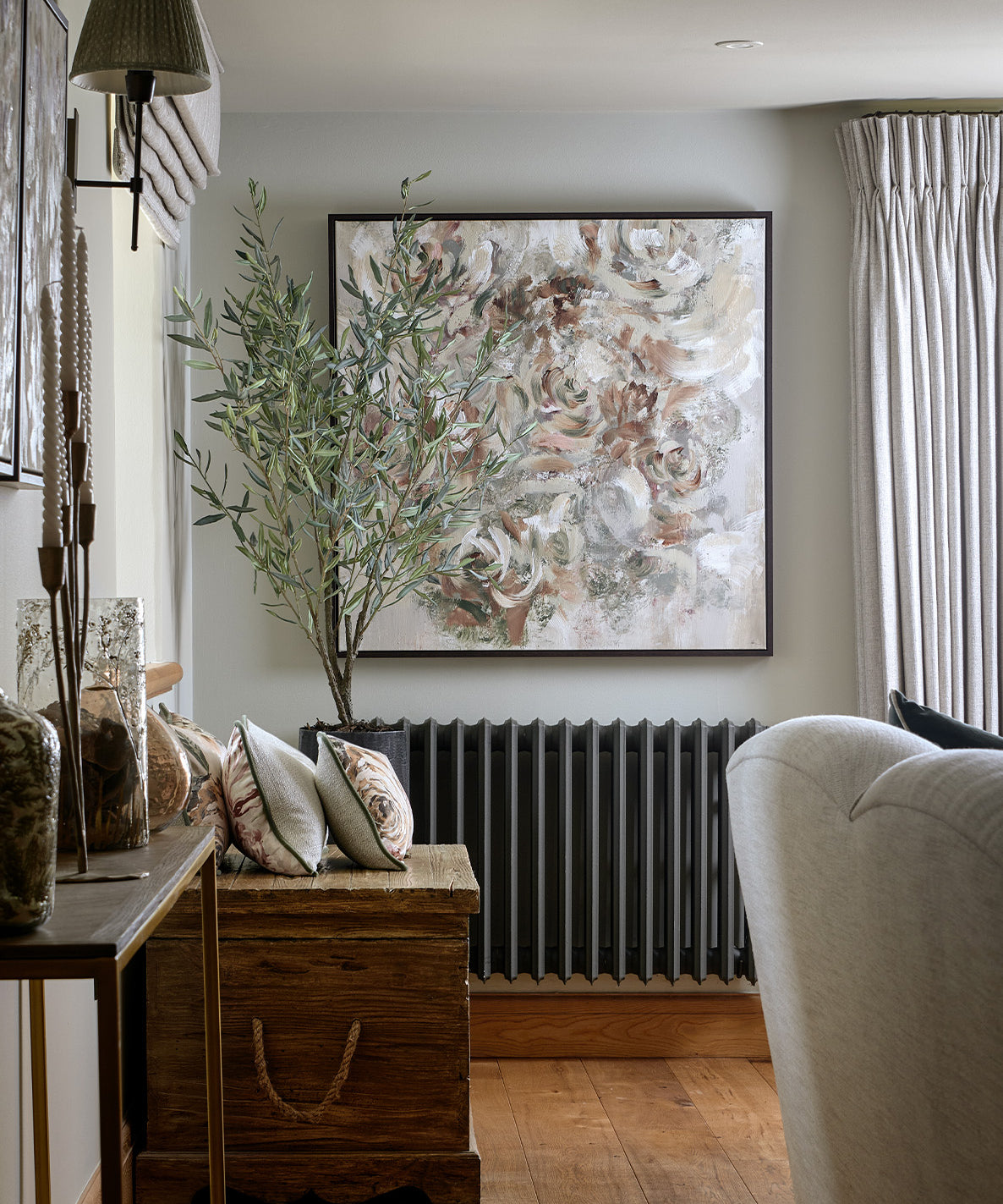 Living room with a wooden console table, decorative pillows, and a large abstract painting on the wall.