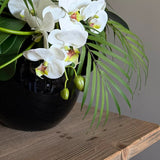 Orchids with Fern and Dianthus  in a Black Goldfish Bowl