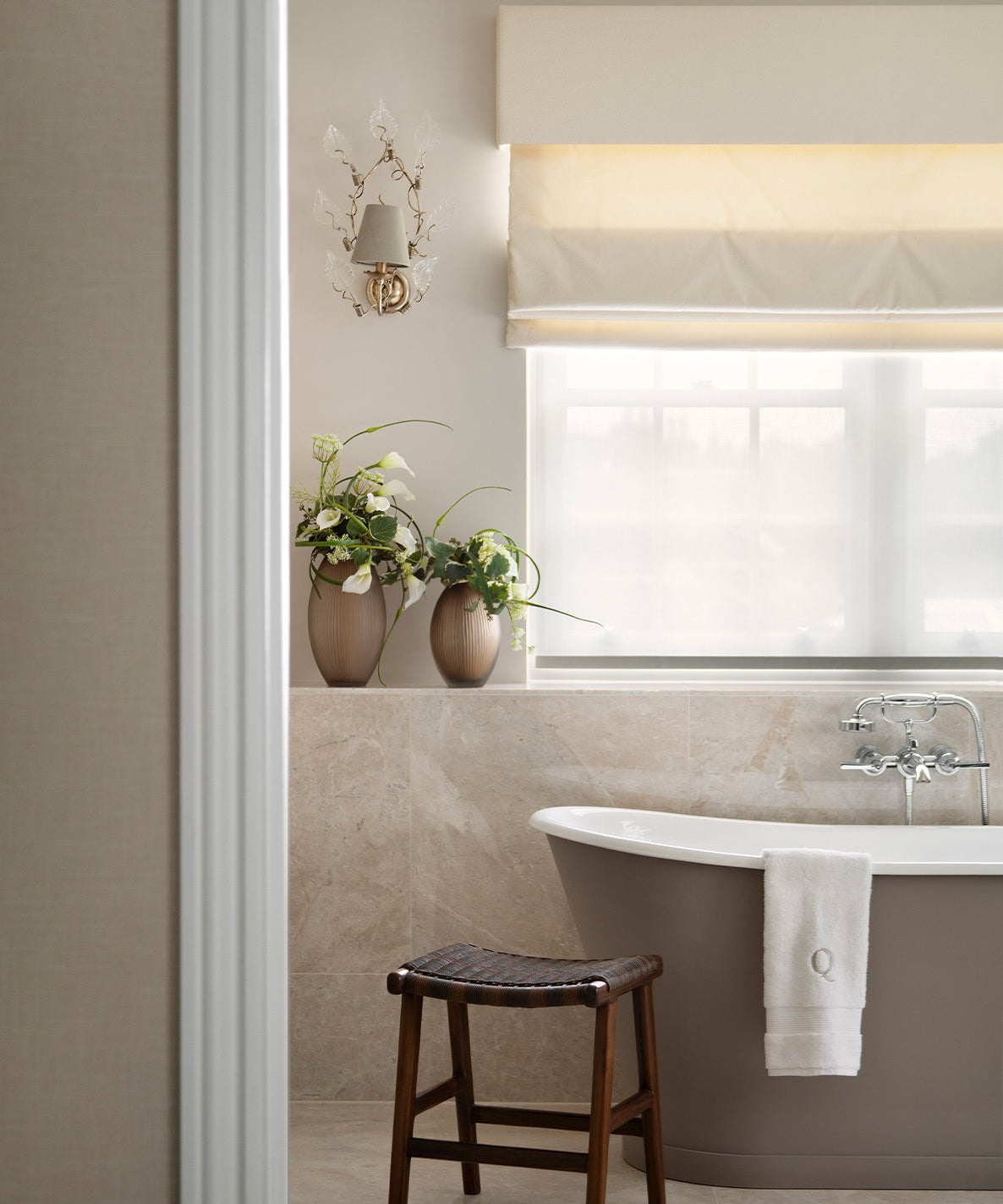 Bathroom with a bathtub, stool, and decorative elements