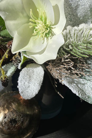 Hellebores, Frosted Pine, Cones in a Bronze Silver Vase