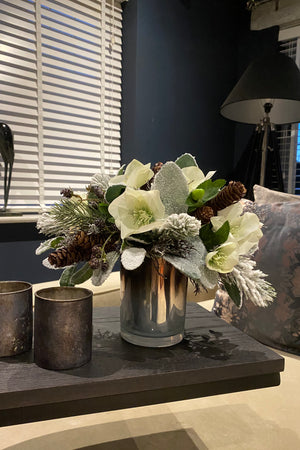 Hellebores, Frosted Pine, Cones in a Bronze Silver Vase